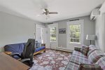 Den with futon, ceiling fan, mini spilt AC unit and desk